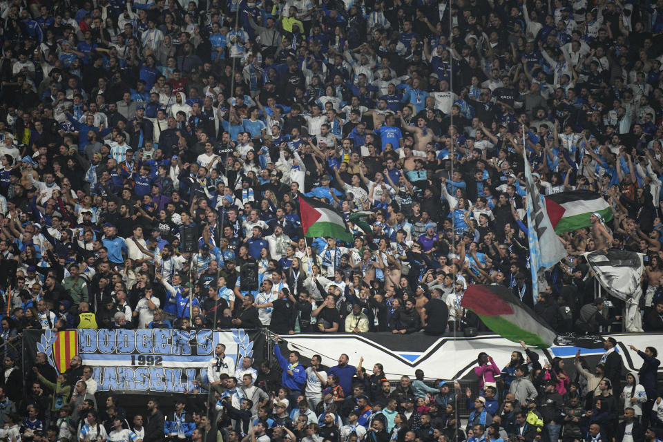 Marseille fans wait for the start of the French League One soccer match between Olympique de Marseille and Lyon at the Velodrome Stadium, in Marseille, France, Sunday, Oct. 29, 2023. (AP Photo/Daniel Cole)