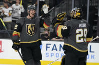 Vegas Golden Knights goaltender Marc-Andre Fleury (29) celebrates after defenseman Nick Holden, left, scored a goal against the Montreal Canadiens during the third period in Game 1 of an NHL hockey Stanley Cup semifinal playoff series Monday, June 14, 2021, in Las Vegas. (AP Photo/John Locher)