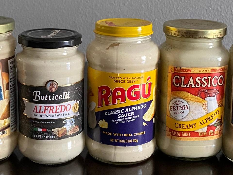 Ragu Alfredo sauce jar on a black table