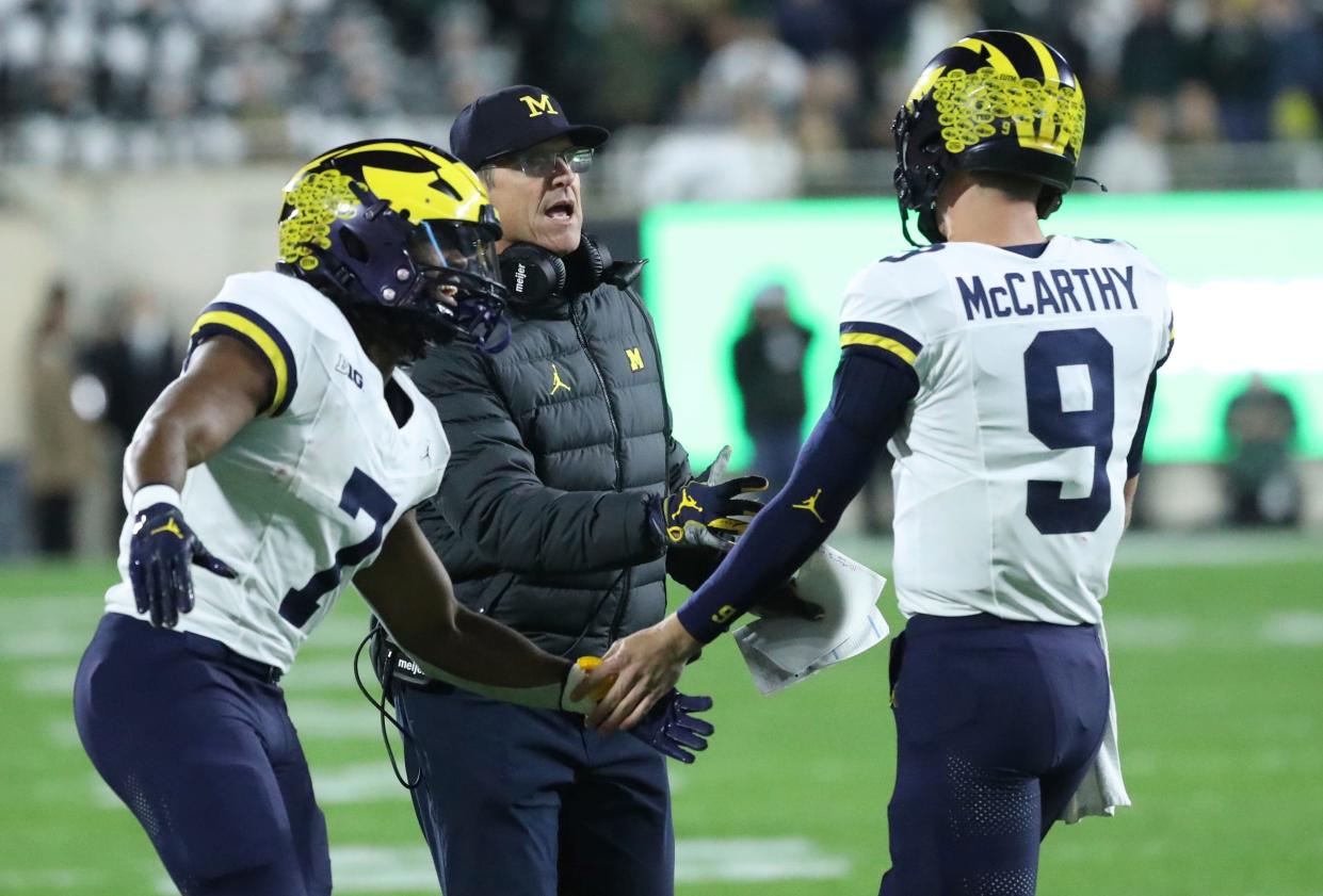 ]Michigan Wolverines head coach Jim Harbaugh, Donovan Edwards (7) J.J. McCarthy (9) celebrate after a touchdown against the Michigan State Spartans during first-half action at Spartan Stadium in East Lansing on Saturday, Oct. 21, 2023.