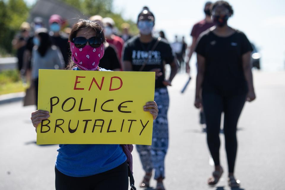 <p>Protesters march in Bridgewater, New Jersey, on 13 June 2020 during a demonstration against police brutality and racism following the murder of George Floyd in Minneapolis on 25 May. </p> ((Photo by NICHOLAS KAMM/AFP via Getty Images))