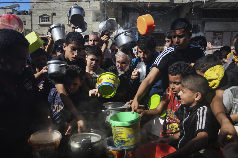 Palestinians crowded together as they wait for food distribution in Rafah, southern Gaza Strip, Wednesday, Nov. 8, 2023. Since the start of the Israel-Hamas war, Israel has limited the amount of food and water allowed to enter the territory, causing widespread hunger across the strip (AP Photo/Hatem Ali)