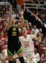 Oregon's Sabrina Ionescu (20) rebounds over Stanford's Lacie Hull, right, during the third quarter of an NCAA college basketball game Monday, Feb. 24, 2020, in Stanford, Calif. (AP Photo/Ben Margot)