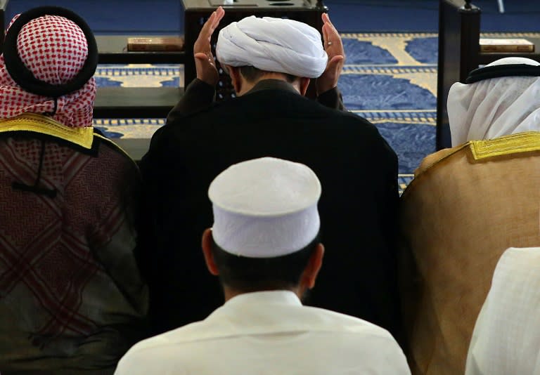 Kuwaiti Sunni and Shiite worshipers perform Friday prayers together in an act of solidarity at Kuwait's Sunni Grand Mosque in Kuwait City on July 3, 2015