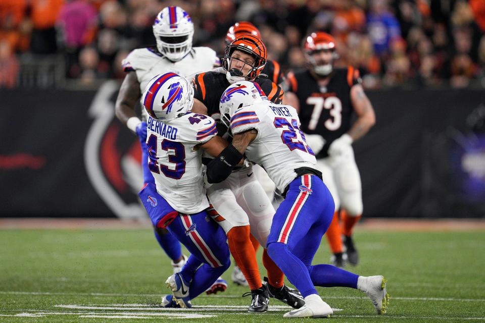 CINCINNATI, OHIO - NOVEMBER 05: Drew Sample #89 of the Cincinnati Bengals is tackled by Terrel Bernard #43 and Jordan Poyer #21 of the Buffalo Bills during the second quarter at Paycor Stadium on November 05, 2023 in Cincinnati, Ohio. (Photo by Jeff Dean/Getty Images)
