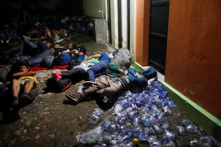 Honduran migrants, part of a caravan trying to reach the U.S., rest on a street during a new leg of their travel in Chiquimula, Guatemala October 17, 2018. REUTERS/Edgard Garrido