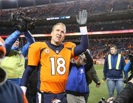 Denver Broncos quarterback Peyton Manning (18) waves as he leaves the field after the game against the San Diego Chargers during the 2013 AFC divisional playoff football game at Sports Authority Field at Mile High. Matthew Emmons-USA TODAY Sports