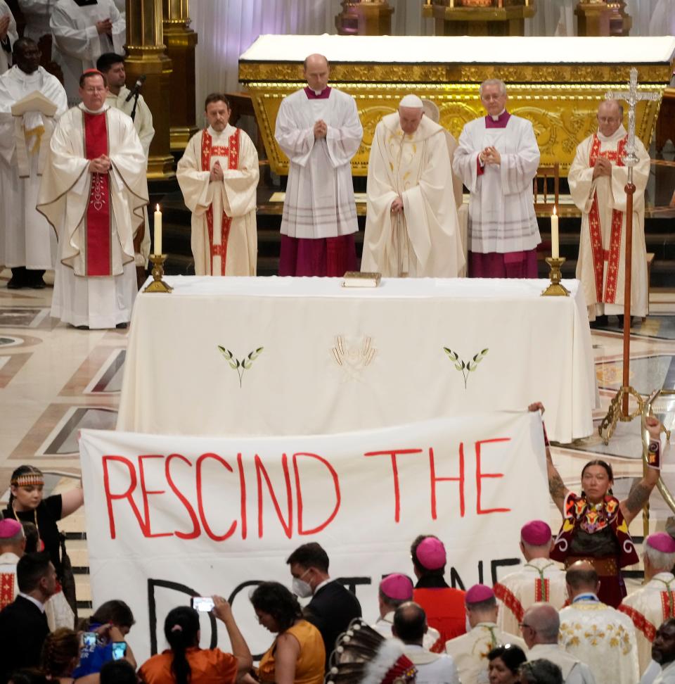 Protectors display a banner urging Pope Francis to "Rescind the Doctrine of Discovery" at a mass in Quebec City, Canada, on July 28, 2022.