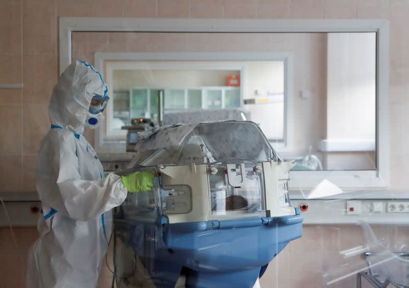 A medical specialist takes care of a newborn baby at a maternity ward of a hospital in Moscow