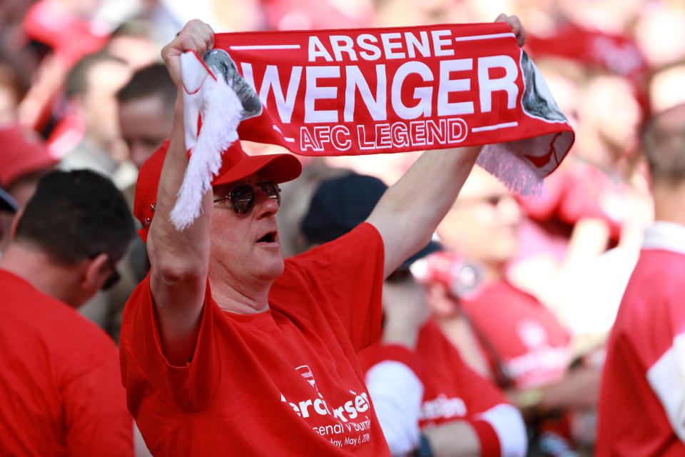 <p>Soccer Football – Premier League – Arsenal vs Burnley – Emirates Stadium, London, Britain – May 6, 2018 Fan holds up a scarf in reference to Arsenal manager Arsene Wenger before the match REUTERS/Ian Walton EDITORIAL USE ONLY. No use with unauthorized audio, video, data, fixture lists, club/league logos or “live” services. Online in-match use limited to 75 images, no video emulation. No use in betting, games or single club/league/player publications. Please contact your account representative for further details. </p>