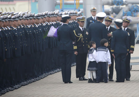 Japanese navy officers are greeted as their Maritime Self-Defense Force destroyer JS Suzutsuki (DD 117) arrives at Qingdao Port for the 70th anniversary celebrations of the founding of the Chinese People's Liberation Army Navy (PLAN), in Qingdao, China April 21, 2019. REUTERS/Jason Lee
