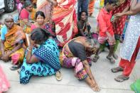 Indian supporters of Tamil Nadu Chief Minister Jayalalithaa Jayaram react as they wait to catch a glimpse of her funeral procession in Chennai on December 6, 2016