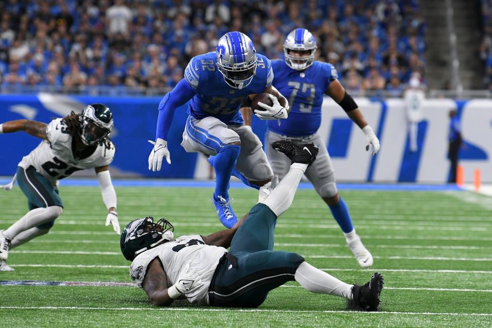 Detroit Lions running back D'Andre Swift (32) jumps over Philadelphia Eagles defensive tackle Javon Hargrave, bottom, in the second half of an NFL football game in Detroit, Sunday, Sept. 11, 2022. (AP Photo/Lon Horwedel)