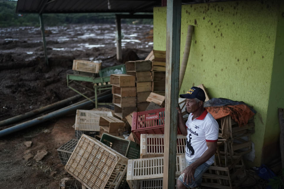 A man looks at the mud next what remains of a market after a dam collapse near Brumadinho, Brazil, Saturday, Jan. 26, 2019. Rescuers in helicopters searched for survivors while firefighters dug through mud in a huge area in southeastern Brazil buried by the collapse of a dam holding back mine waste, with at least nine people dead and up to 300 missing. (AP Photo/Leo Correa)