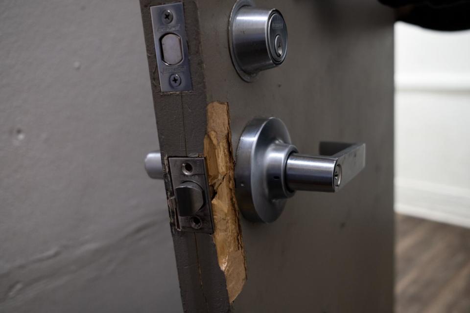 A door at the Baltimore shows signs of damage around the handle and lock.