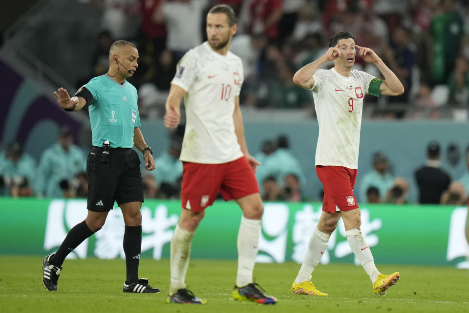 Poland's Robert Lewandowski, right, gestures after he scores his side's second goal during the World Cup group C soccer match between Poland and Saudi Arabia, at the Education City Stadium in Al Rayyan , Qatar, Saturday, Nov. 26, 2022. (AP Photo/Francisco Seco)
