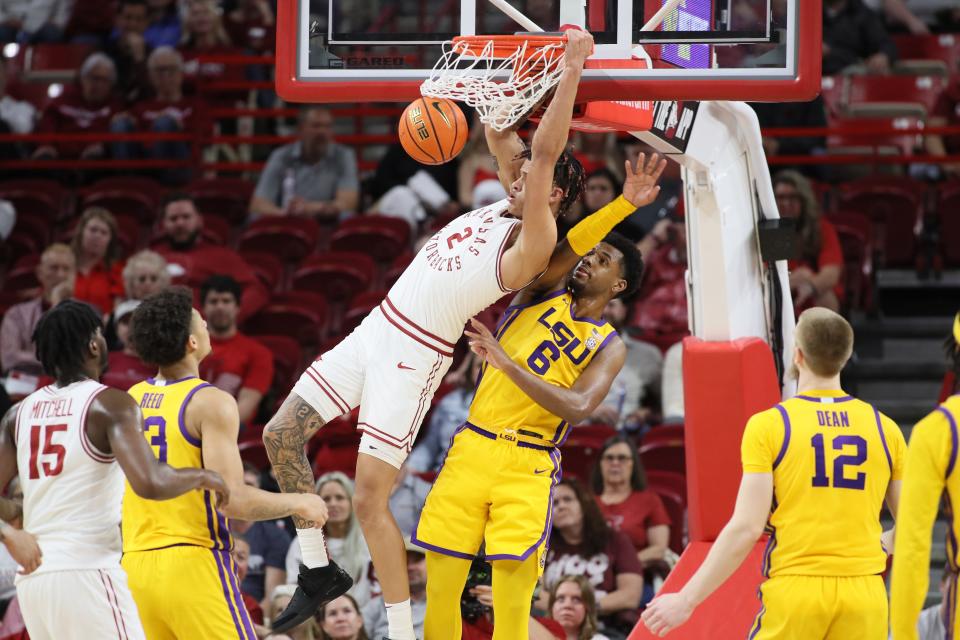 Mar 6, 2024; Fayetteville, Arkansas, USA; Arkansas Razorbacks forward Trevon Brazile (2) dunks the ball in the first half as LSU Tigers guard Jordan Wright (6) defends at Bud Walton Arena. Mandatory Credit: Nelson Chenault-USA TODAY Sports