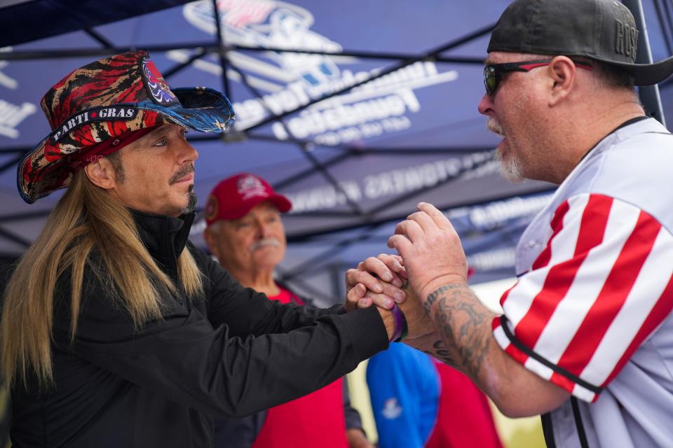 Bret Michaels, frontman for Poison, at left, speaks with Dave Gibson, at right, during an event for homeless veterans at Grand Veterans Village on Thursday, Nov. 3, 2022, in Phoenix.