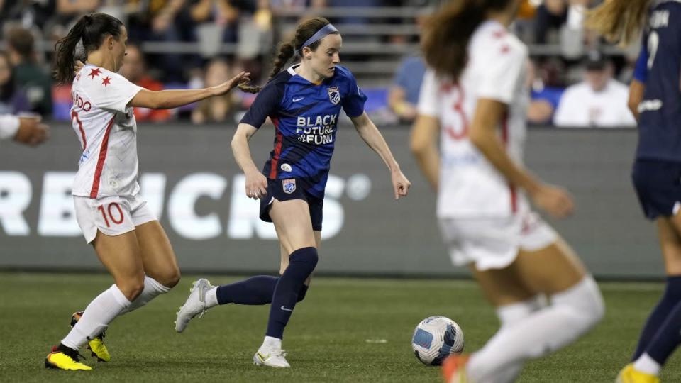 Rose Lavelle of OL Reign dribbles the soccer ball