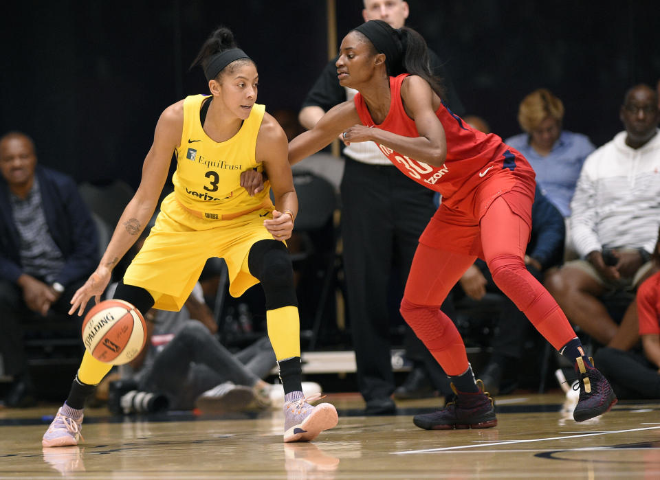 Los Angeles Sparks forward Candace Parker (L) dribbles against Washington Mystics forward LaToya Sanders (R) in the first half of a single elimination WNBA basketball playoff game, Thursday, Aug. 23, 2018, in Washington. (AP Photo)