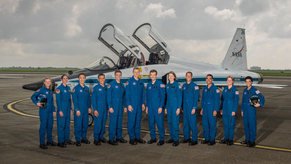 The 2017 NASA Astronaut Class: (from left) Zena Cardman, Jasmin Moghbeli, Jonny Kim, Frank Rubio, Matthew Dominick, Warren Hoburg, Robb Kulin, Kayla Barron, Bob Hines, Raji Chari, Loral O'Hara and Jessica Watkins. <cite>Robert Markowitz/NASA</cite>