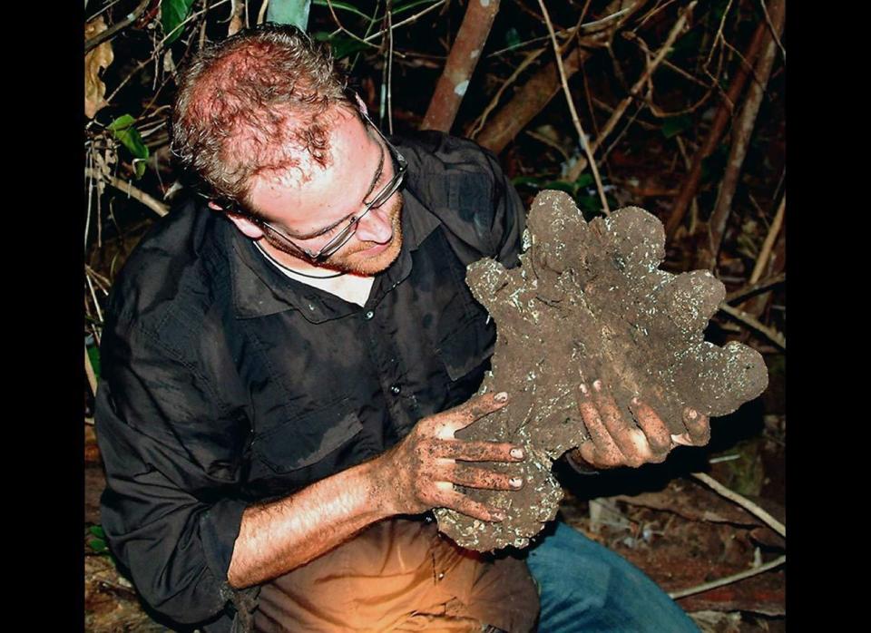 Josh Gates, host of Syfy TV's "Destination: Truth," holds a plaster cast of what Malaysian ghost hunters said was a Bigfoot footprint in 2006.