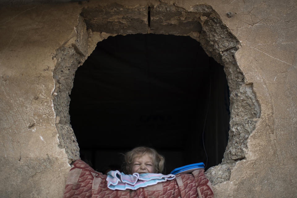 Iraqi girl looks out a window