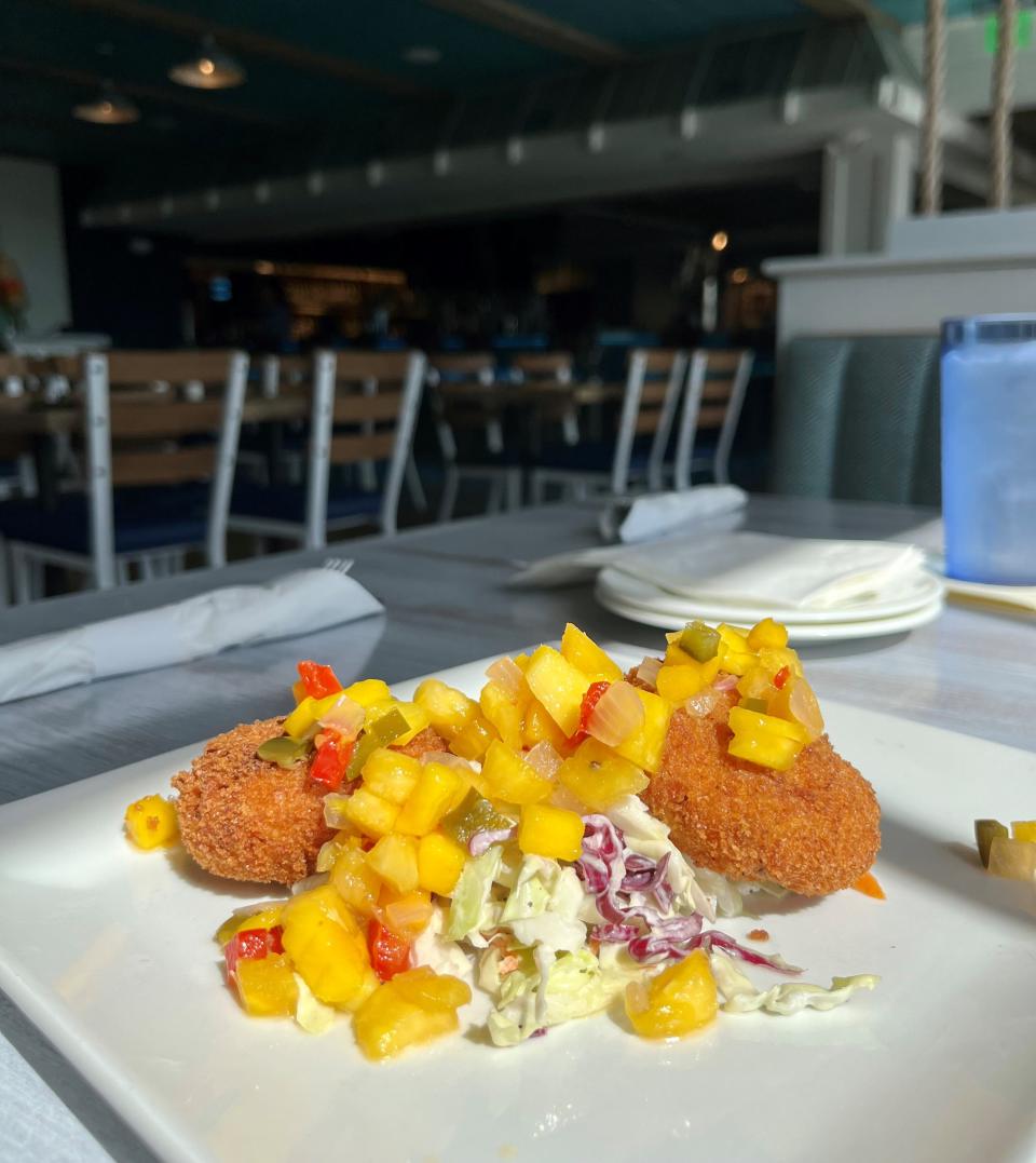 The Shipyard's Captiva crab cakes are filled with lump crab and served with house-made cider cole slaw and tropical fruit salad.