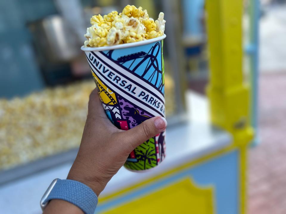 The author holding up a cup of popcorn at Universal.