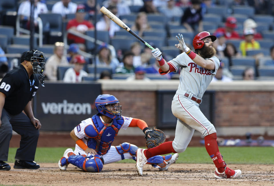 Philadelphia Phillies' Brandon Marsh, right, follows through on a home run against the New York Mets during the ninth inning of a baseball game, Sunday, Oct. 1, 2023, in New York. (AP Photo/Noah K. Murray)