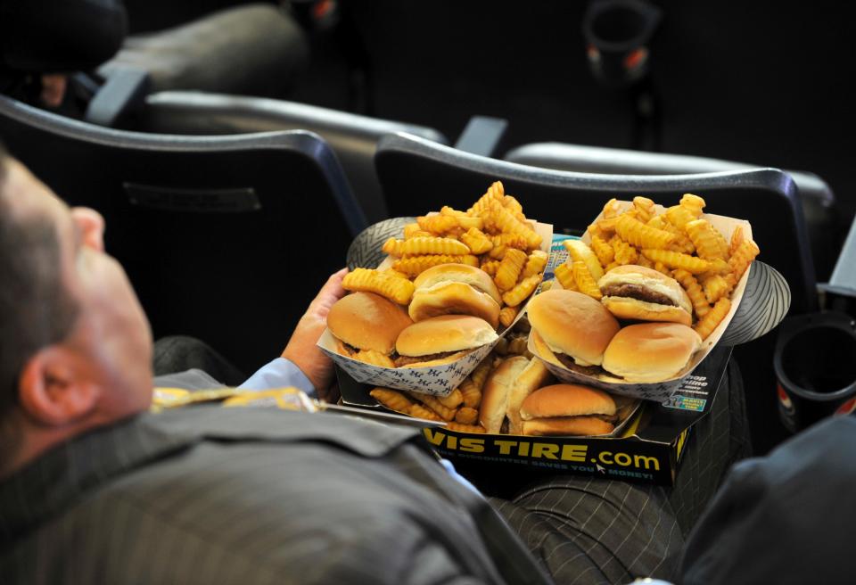 A fan with piles of hamburgers and fries at Yankee Stadium in 2009. (Getty Images)