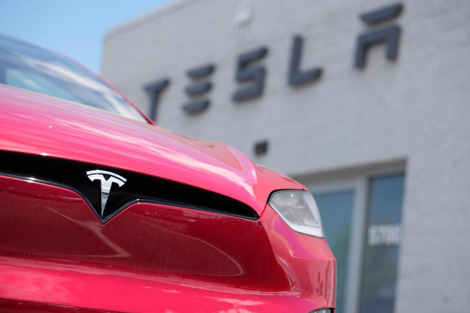 An unsold 2023 Model X sports-utility vehicle sits outside a Tesla dealership in June in Littleton, Colo.