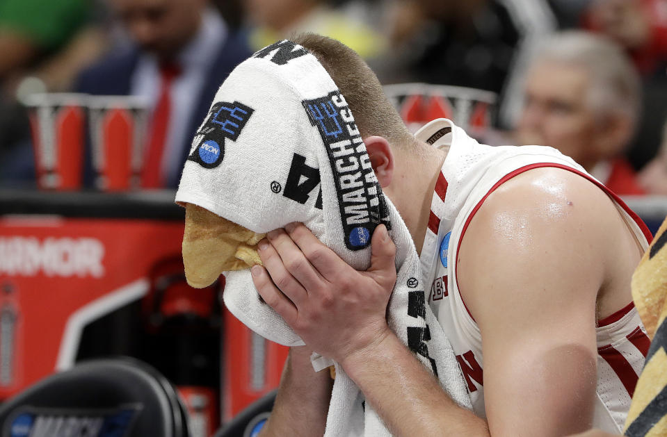 Wisconsin guard Brad Davison sits on the bench with a towel over his face during the second half of a first-round game against Oregon in the NCAA men’s college basketball tournament Friday, March 22, 2019, in San Jose, Calif. (AP Photo/Chris Carlson)