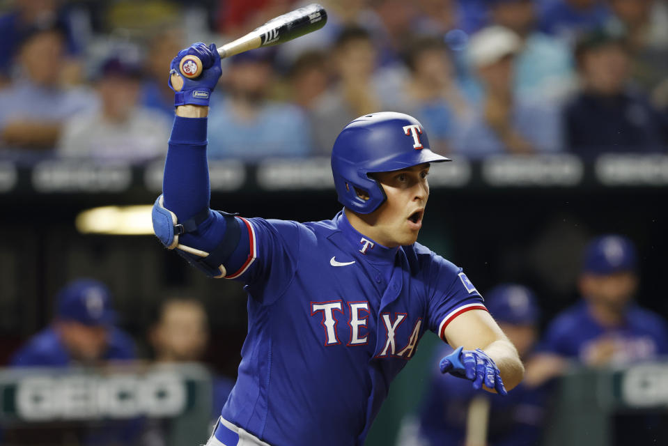 Texas Rangers' Nathaniel Lowe follows through on a hit during the sixth inning of a baseball game against the Kansas City Royals in Kansas City, Mo., Monday, June 27, 2022. (AP Photo/Colin E. Braley)