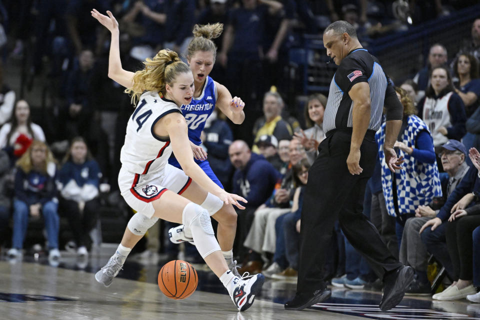 Creighton's Morgan Maly (30) fouls UConn's Dorka Juhasz (14) during the second half of an NCAA college basketball game Wednesday, Feb. 15, 2023, in Storrs, Conn. (AP Photo/Jessica Hill)