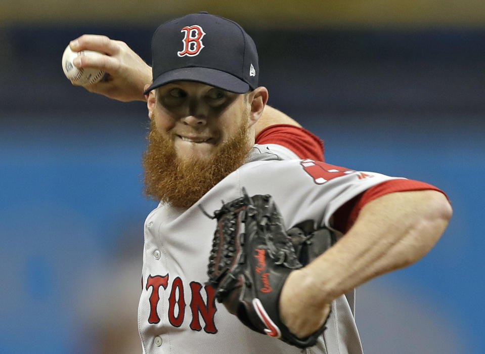 FILE - In this March 31, 2018, file photo, Boston Red Sox relief pitcher Craig Kimbrel delivers to the Tampa Bay Rays during the ninth inning of a baseball game, in St. Petersburg, Fla. Free-agent closer Craig Kimbrel has agreed to a contract with the Chicago Cubs. The team said Friday, June 7, 2019, he has passed his physical. Contract terms were not disclosed.(AP Photo/Chris O'Meara, File)