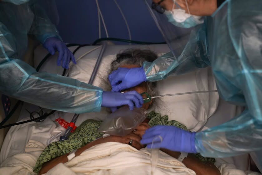 FILE - In this Jan. 7, 2021, file photo, two nurses put a ventilator on a patient in a COVID-19 unit at St. Joseph Hospital in Orange, Calif. U.S. hospital intensive care units in many parts of the country are straining under record numbers of COVID-19 patients. (AP Photo/Jae C. Hong, File)