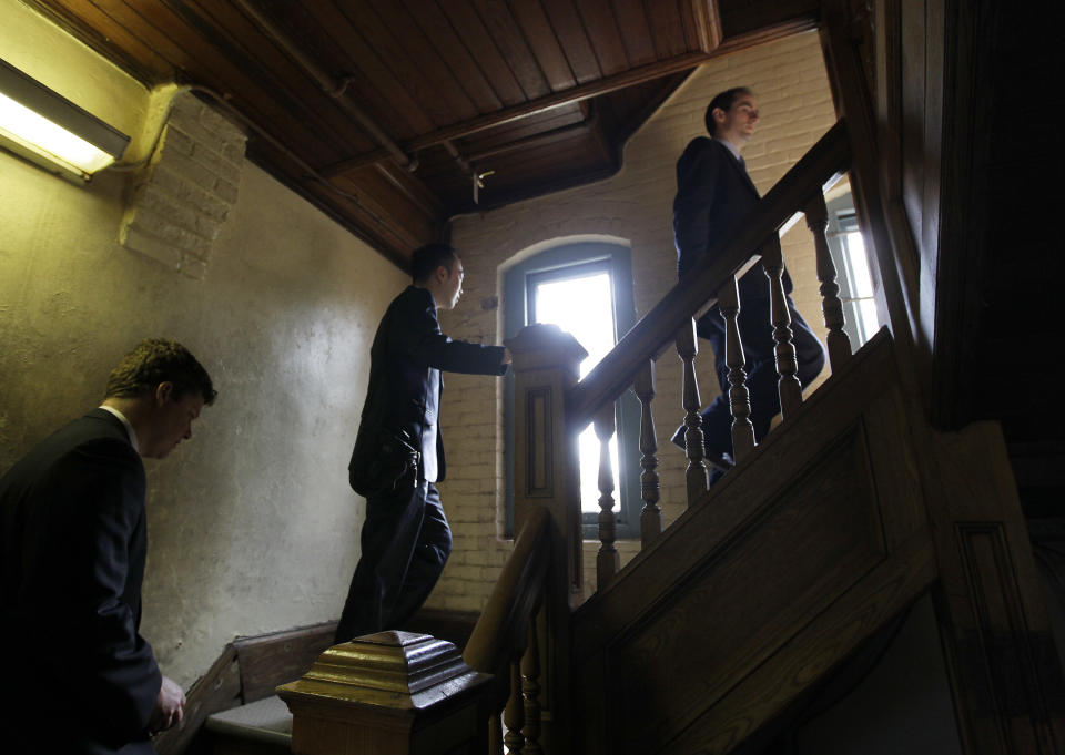 Interested people from Olivet University and the World Evangelical Alliance climb stairs during a tour of buildings on an historic 217-acre campus in Northfield, Mass., in this photo taken Thursday, March 8, 2012. The campus, along with its 43 buildings, is being offered for free to an orthodox Christian group who can come up a solid plan to use it. (AP Photo/Elise Amendola)