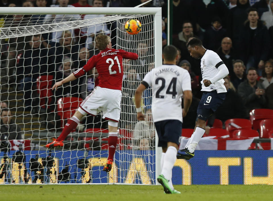 England's Daniel Sturridge, right, scores against Denmark during the international friendly soccer match between England and Denmark at Wembley Stadium in London, Wednesday, March 5, 2014. (AP Photo/Sang Tan)