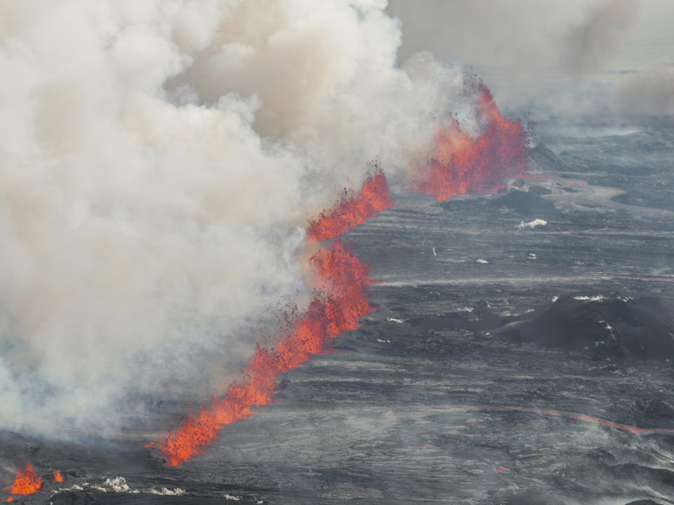 An eruptive fissure spews lava and smoke from a volcano in Grindavik, Iceland, Wednesday, May 29, 2024. A volcano in southwestern Iceland erupted Wednesday for the fifth time since December, spewing red lava that once again threatened the coastal town of Grindavik and led to the evacuation of the popular Blue Lagoon geothermal spa. (AP Photo/Marco di Marco)