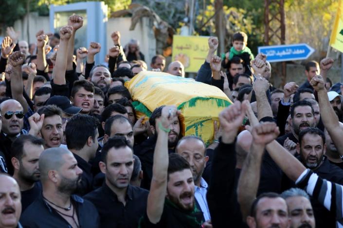 Mourners chant slogans as they carry the body of Adel Termos, killed in a twin bombing attack, during his funeral in the village of Tallussa in the Nabatiyeh governorate on November 13, 2015 (AFP Photo/Mahmoud Zayyat)