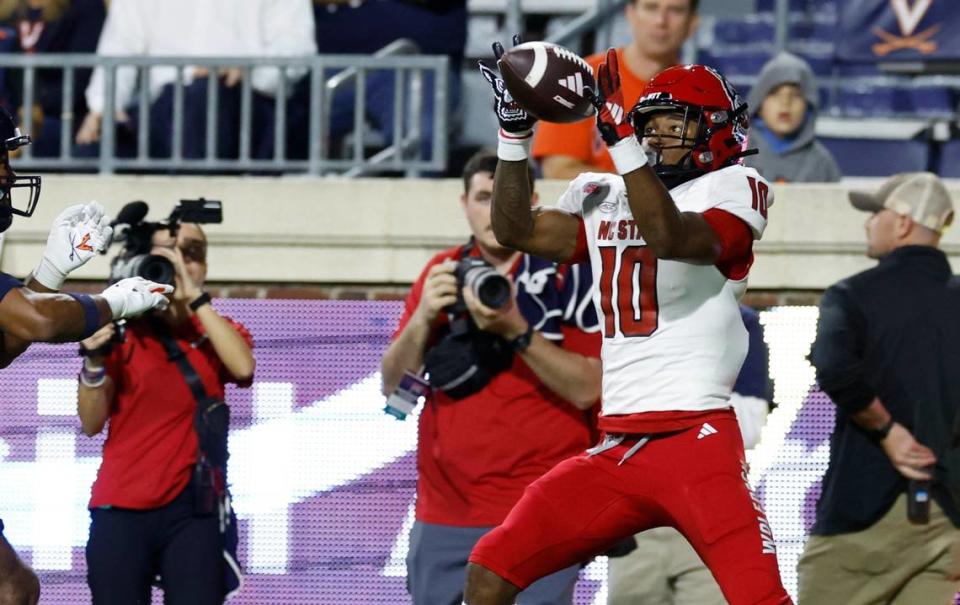 N.C. State wide receiver Kevin ‘KC’ Concepcion (10) pulls in a 12-yard touchdown reception during the first half of N.C. State’s game against Virginia at Scott Stadium in Charlottesville, Va., Friday, Sept. 22, 2023.