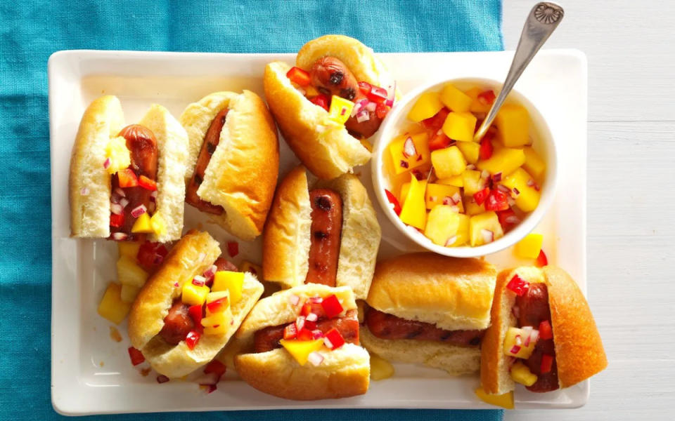 <p>Taste of Home</p><p>A new take on a slider—these come with a sweet mango salsa topping.</p><p><strong>Get the recipe: <a href="https://parade.com/1073832/parade/hot-dog-sliders-with-mango-pineapple-salsa/" rel="nofollow noopener" target="_blank" data-ylk="slk:Hot Dog Sliders;elm:context_link;itc:0;sec:content-canvas" class="link ">Hot Dog Sliders</a></strong></p>