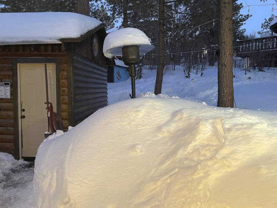 David and Kelli Góra dig out from a snowstorm that struck their home in Big Bear Lake, California, on Wednesday, March 1, 2023. (David Góra via AP)