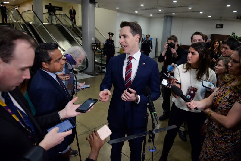 Sen. Josh Hawley (R-MO) talks to reporters on the stairs near the Senate Subway on his way to the Senate impeachment trial of President Trump in Washington