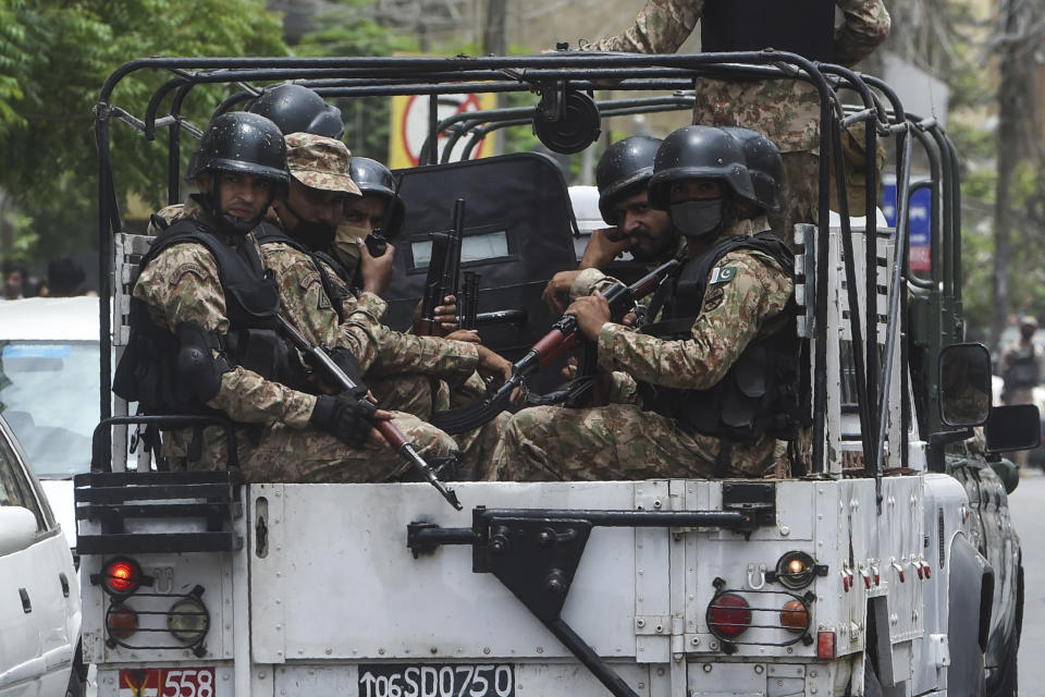 Paramilitary soldiers patrol near the Pakistan Stock Exchange building following an attack by gunmen in Karachi on June 29, 2020. - At least six people were killed when gunmen attacked the Pakistan Stock Exchange in Karachi on June 9, with a policeman among the dead after the assailants opened fire and hurled a grenade at the trading floor, authorities said. (Photo by Asif HASSAN / AFP) (Photo by ASIF HASSAN/AFP via Getty Images)