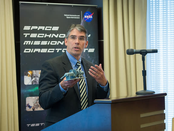 Michael Gazarik, Associate Administrator, NASA Space Technology Mission Directorate, holds up a model thruster at a Green Propellant Infusion Mission press conference at the Reserve Officers Association, Tuesday, July 9, 2013 in Washington.