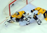 Feb 21, 2019; Nashville, TN, USA; Nashville Predators goaltender Pekka Rinne (35) makes a save on a redirect attempt from Los Angeles Kings right wing Dustin Brown (23) as Nashville Predators defenseman Roman Josi (59) defends during the first period at Bridgestone Arena. Mandatory Credit: Christopher Hanewinckel-USA TODAY Sports