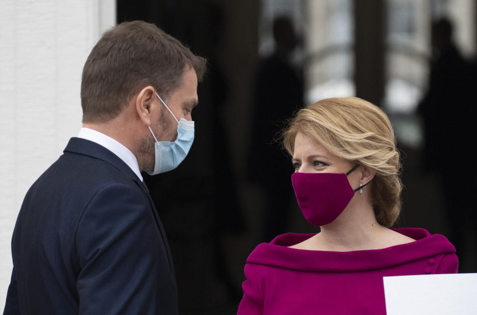 Newly appointed Slovak Prime Minister Igor Matovic (L), leader of the OLaNO anti-graft party talks with President Zuzana Caputova after a swearing in ceremony of the new four-party coalition government on March 21, 2020 outside of the Presidential palace in Bratislava. - The ceremony was held without members of the press and all appointed government members wore gloves and face mask to prevent the spread of novel coronavirus. (Photo by JOE KLAMAR / AFP) (Photo by JOE KLAMAR/AFP via Getty Images)