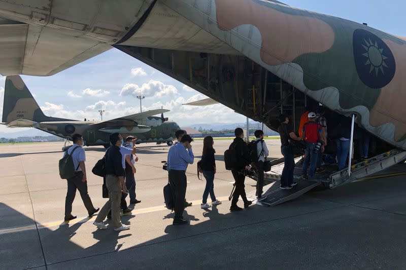 Journalists board a Taiwan Air Force C-130 transport aircraft in Taipei